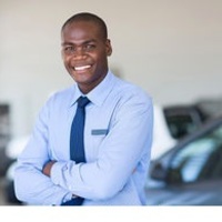 Medium african car salesman portrait portrait of happy african car salesman in showroom stock image csp26524066